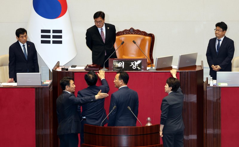 송언석(아래 왼쪽 두번째) 국민의힘 비상대책위원장 겸 원내대표와 유상범 원내운영수석, 김은혜 원내정책수석이 4일 오후 서울 여의도 국회 본회의장에서 더불어민주당의 내부사정으로 본회의가 지연되는 것에 대해 우원식 국회의장에게 항의를 하고 있다. 이에 문진석(아래 왼쪽) 민주당 원내운영수석이 양해를 구하고 있다. 사진&#x3D;뉴시스