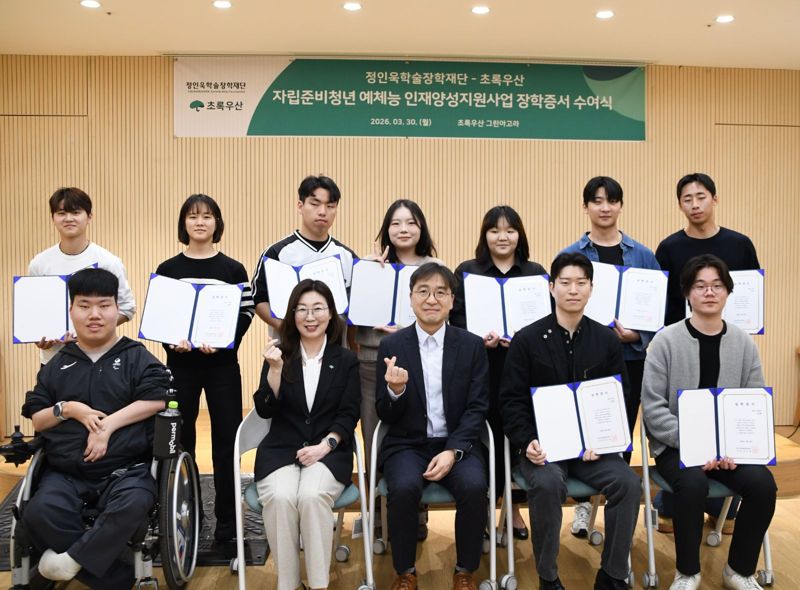 유용재 정인욱학술장학재단 사무국장(앞줄 왼쪽 세번째), 신정원 초록우산 사회공헌협력본부장(앞줄 왼쪽 두 번째)이 지난 3월 30일 서울 중구 초록우산 그린아고라에서 열린 장학금 수여식에서 장학생들과 함께 기념촬영을 하고 있다. 정인욱학술장학재단 제공