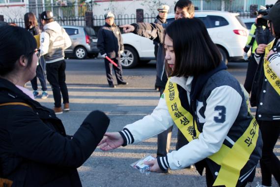 수능일인 13일 오전 경남은행 대학생 홍보대사들이 고사장 입구에서 수험생들에게 따뜻한 음료·핫팩·간식 등 각종 물품을 전달하며 사기를 북돋아주고 있다.