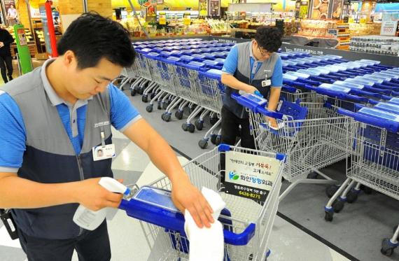 4일 오전 서울 홈플러스 영등포점에서 직원들이 카트 손잡이를 소독 하고 있다. <사진제공=홈플러스>