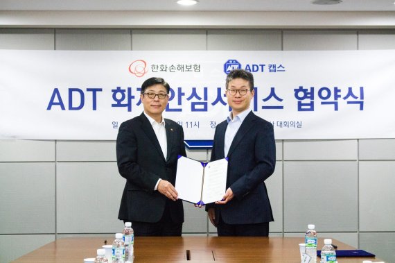 최진환 ADT캡스 대표이사(왼쪽)와 박윤식 한화손해보험 대표이사가 5일 협약식 이후 기념사진을 찍고 있다.