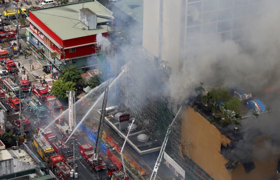18일(현지시간) 불이 난 필리핀 마닐라의 22층짜리 워터프론트 마닐라 파빌리온 호텔에서 진화작업이 진행되고 있다. 현지 언론은 카지노를 갖춘 이 호텔의 화재로 4명이 숨지고 6명이 부상했으며 20명 가량이 호텔 안에 갇혀 있다고 전했다. 소방당국은 구조작업을 진행하며 불이 고층으로 확산하는 것을 막고 있다고 밝혔다. 연합뉴스