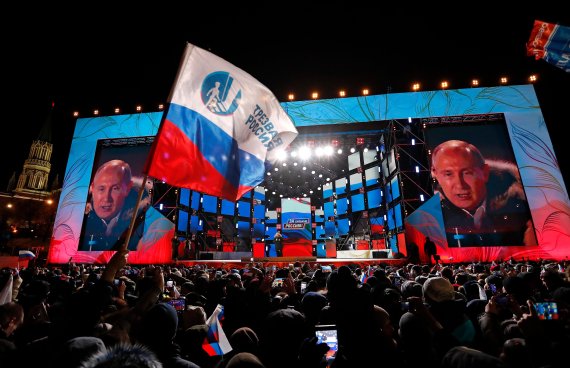 Russian President Vladimir Putin speaks to supporters during a rally near the Kremlin in Moscow, Sunday, March 18, 2018. An exit poll suggests that Vladimir Putin has handily won a fourth term as Russia's president, adding six more years in the Kremlin for the man who has led the world's largest cou