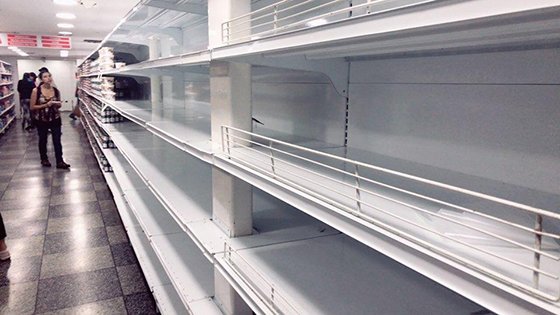 지난 26일 베네수엘라 카라카스 소재 대형 슈퍼마켓 '엑셀시오 가마'의 텅 비어있는 진열대를 현지인이 바라보고 있다. 정부의 가격 통제로 공장이 생산을 중단하자 시장에 공급되는 물건이 사라진 셈이다. 사진=김문희 기자