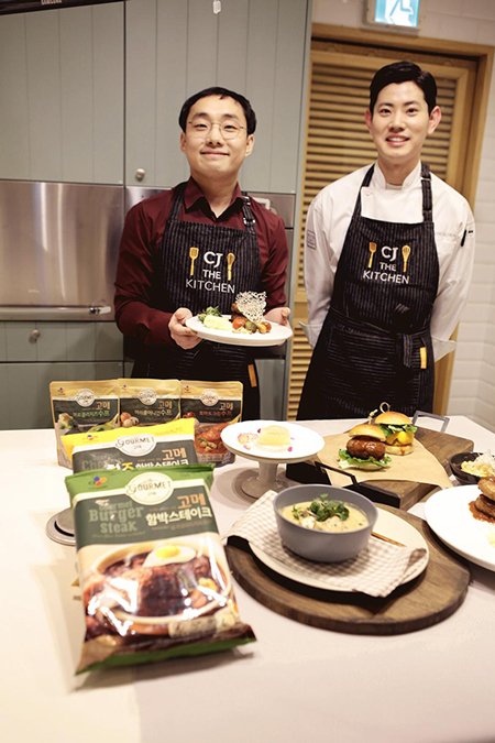지난 3월 서울 동호로 CJ제일제당 'CJ 더 키친 쿠킹스튜디오'에서 간편식을 활용한 일일 요리 실습에서 김기훈 더 키친 쿠킹스튜디오 전임 셰프(오른쪽)와 기자가 CJ 간편식 제품으로 완성한 요리를 선보이고 있다.