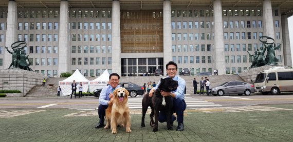 바른미래당 반려동물특별위원회 의원장인 정병국 의원(오른쪽)과 바른미래당 정운천 최고위원이 17일 국회의사당에서 영화 '곡성' 등에 출연한 개들과 사진을 찍고 있다.