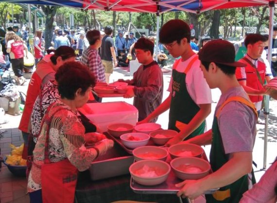 지난 16일 청주 중앙공원에서 롯데푸드 청주공장 샤롯데 봉사단이 지역 어르신들을 위한 무료 급식 봉사 활동을 하고 있다.