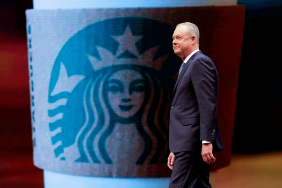 (FILES) In this file photo taken on March 21, 2018 Starbucks President and Chief Executive Officer Kevin Johnson walks on stage at the Starbucks Annual Meeting of Shareholders at McCaw Hall in Seattle, Washington on March 21, 2018. / AFP PHOTO / <All rights reserved by Yonhap News Agency>