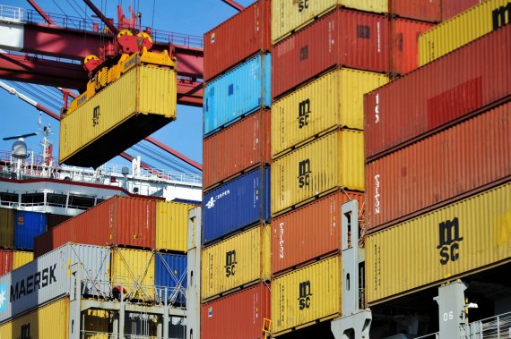 FILE - In this April 8, 2018 file photo, a container is loaded onto a cargo ship at a port in Qingdao in east China's Shandong province. China has accused the United States on Thursday, June 21, 2018, of using pressure tactics and blackmail in threatening to impose tariffs on hundreds of billions of