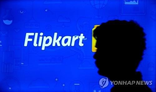 visitor is silhouetted as he walk past the logo of Flipkart at SURGE 2016 event for startup businesses at Manpho convention centre, in Bangalore, India, 24 February 2016. Flipkart, India's largest online retailer on 10 April 2017 announced that it had raised 1.4 billion USD in capital from eBay, Ten