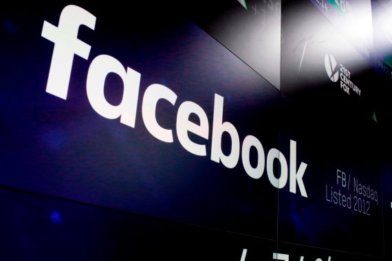 FILE - In this March 29, 2018, file photo, the logo for Facebook appears on screens at the Nasdaq MarketSite in New York's Times Square. Facebook says it recently discovered a security breach affecting nearly 50 million user accounts. The hack is the latest setback for Facebook during a year of tumu