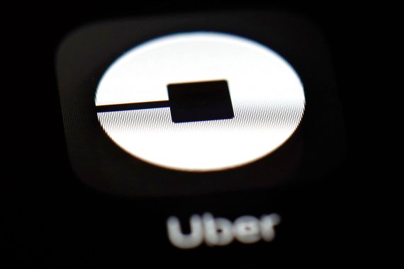 FILE - This March 20, 2018, file photo shows the Uber app on an iPad in Baltimore. Uber may put forth an initial public offering early next year that values the ride-hailing business at as much as $120 billion, according to a media report. The Wall Street Journal said Tuesday, Oct. 16, that Uber Tec