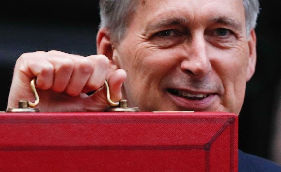 British Chancellor of the Exchequer Philip Hammond poses for pictures with the Budget Box as he leaves 11 Downing Street in London, on October 29, 2018, before presenting the government's annual Autumn budget to Parliament. - Chancellor of the Exchequer, Hammond will try to navigate a political mine