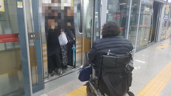 지난 12일 오후 6시 서울 동작구 9호선 동작역 승강장에서 지체장애인 이형숙 노들장애인자립생활센터 소장이 지하철에 탑승하지 못하고 있다. 휠체어 전용공간이었지만 승객들은 자리를 비켜주지 않았다./사진=최용준 기자