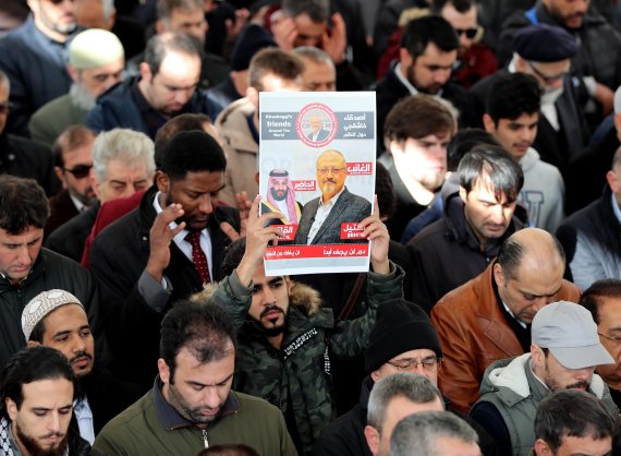 People hold photo of slain Saudi journalist Jamal Khashoggi as they perform a prayer at Fatih Mosque in Istanbul, Turkey, 16 November 2018. According to reports, Saudi Arabia's Attorney General Saud al-Mujeb on 15 November told a press conference that an order to bring back Saudi journalist Jamal Kh