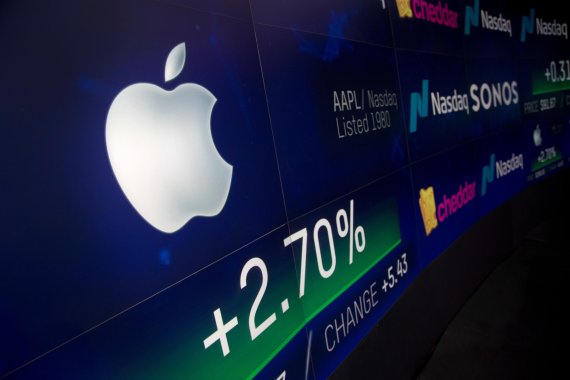 FILE- In this Aug. 2, 2018, file photo an electronic screen displays Apple stock at the Nasdaq MarketSite in New York. Microsoft is threatening to overtake Apple as the world’s most valuable publicly traded company. The market closed Tuesday, Nov. 27, with Microsoft just behind Apple. (AP Photo/Mark