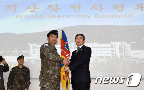 정경두 국방부 장관이 9일 오전 경기도 용인시 처인구 지상작전사령부에서 열린 부대 창설식에서 김운용 초대 지상작전사령관에게 지작사기를 전달하며 악수를 하고 있다. 2019.1.9/뉴스1 © News1 오장환 기자