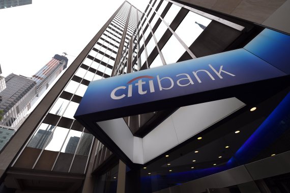 (FILES) In this file photo taken on July 14, 2014 the Citibank Corporate Office & Headquarters is viewed in midtown Manhattan in New York. - Lower expenses helped boost Citigroup's fourth-quarter earnings but heavy volatility dented revenues in some trading divisions, the bank reported on January 14