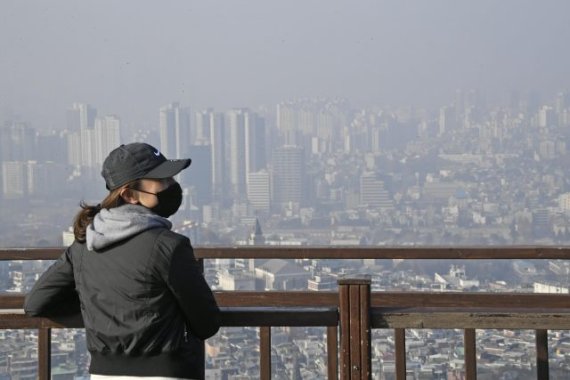 초미세먼지 주의보가 발령된 13일 서울 남산을 찾은 시민이 마스크를 착용한 채 희뿌연 서울시내를 바라보고 있다. 사진=박범준 기자