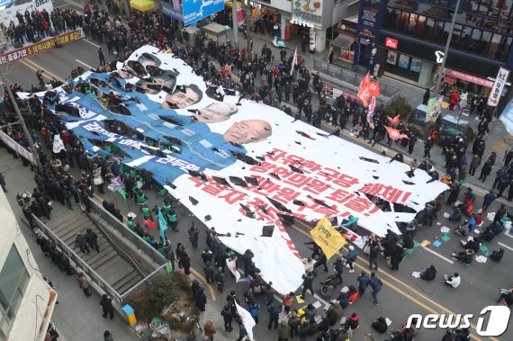 16일 오후 광주 동구 금남로 일원에서 열린 5·18역사왜곡 처벌을 위한 광주범시민궐기 대회가 열린 가운데 자유한국당을 규탄하는 대형 현수막이 찢어지는 퍼포먼스가 진행되고 있다. 현수막에는 죄수복을 입은 지만원씨, 김순례, 김진태, 이종명 의원, 전두환 전 대통령 사진