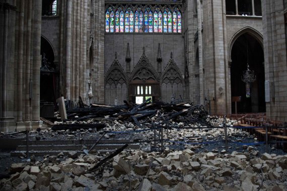 This general view shows debris inside the Notre-Dame-de Paris Cathedral in Paris on April 16, 2019, a day after a fire that devastated the building in the centre of the French capital. - French President Emmanuel Macron vowed on April 16 to rebuild Notre-Dame cathedral 'within five years', after a f