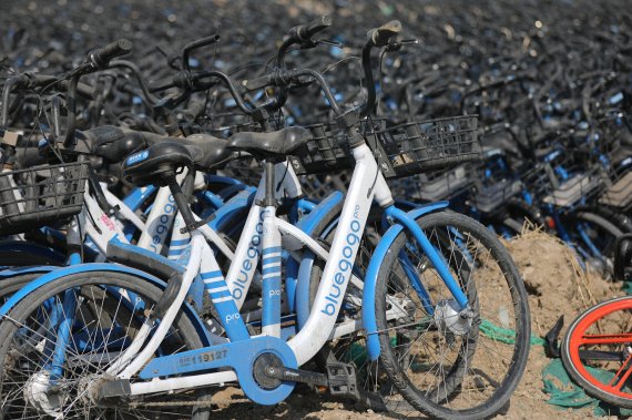 A general view shows rental bicycles in an outdoor parking ground in Beijing, China, 22 March 2018. As many as 70,000 rental bicycles belonging to Bluegogo were moved to this location to wait for repairs and relocation after Bluegogo bicycle rental company closed in November 2017 and was held in tru