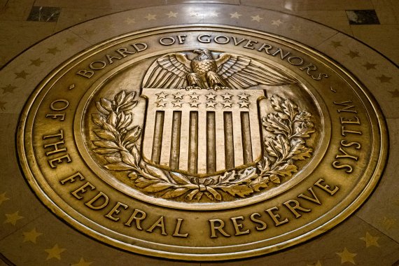 FILE - This Feb. 5, 2018, file photo shows the seal of the Board of Governors of the United States Federal Reserve System in the ground at the Marriner S. Eccles Federal Reserve Board Building in Washington. President Donald Trump says on Twitter he will nominate economists Christopher Waller and Ju
