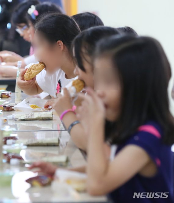 【서울=뉴시스】최진석 기자 = 전국 4601개 국·공립 유치원 및 초·중·고교 비정규직 노동자 9만여 명이 파업에 돌입한 3일 오후 서울 한 초등학교 급식실에서 학생들이 대체급식으로 나온 빵과 음료수를 마시며 점심식사를 하고 있다. 이번 파업으로 전체 학교의 44.1%가 급식을 정상적으로 제공하지 못하게 됐다. 2019.07.03. photo@newsis.com