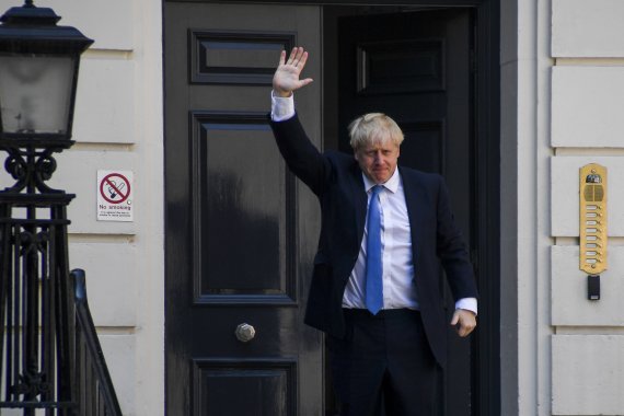 보리스 존슨 영국 총리가 23일(현지시간) 수도 런던의 보수당사 앞에서 손을 흔들고 있다.신화뉴시스