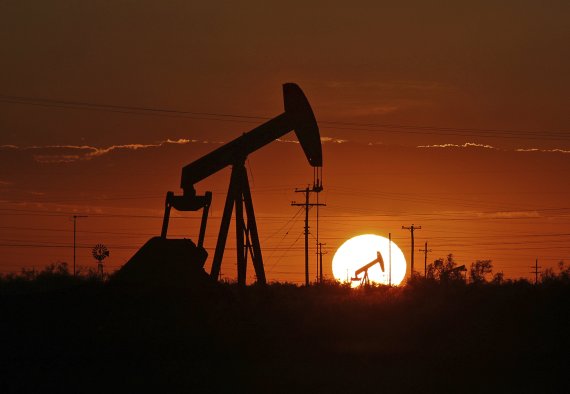 FILE - In this June 11, 2019, file photo a pump jack operates in an oil field in the Permian Basin in Texas. Drilling of the longest horizontal oil and gas well in the history of the Permian Basin has been completed as booming oil production in the region continues to center around shale in southeas