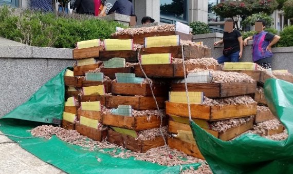 군산지역 꽃새우 잡이 어민들이 군산시수협 앞에서 꽃새우 상자를 세워놓고 농심의 거래 중단에 항의하고 있다. 뉴스1