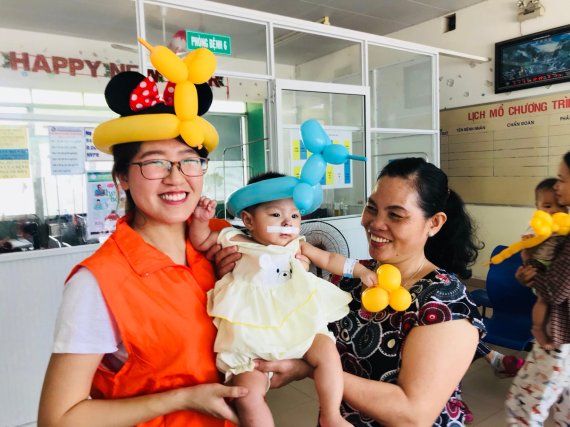 스마일게이트는 연세대학교 의료원과 함께 베트남의 구순구개열 환아 의료지원 협약을 맺었다. 자원봉사자가 환아를 안고 웃고있다. 스마일게이트 제공