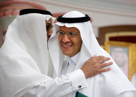 Energy Minister Prince Abdulaziz bin Salman smiles as he is congratulated after a press conference in Jiddah, Saudi Arabia, Tuesday, Sept. 17, 2019. Saudi Arabia's energy minister said Tuesday that 50% of its daily crude oil production that was knocked out by a weekend attack had been restored and t
