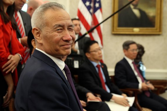 Chinese Vice Premier Liu He listens during a meeting in the Oval Office of the White House with President Donald Trump in Washington, Friday, Oct. 11, 2019. (AP Photo/Andrew Harnik)