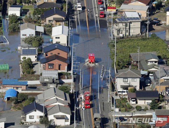 【아시카가=AP/뉴시스】13일 일본 도쿄 북쪽 아시카가 시의 한 도로가 제19호 태풍 하기비스의 영향으로 침수된 가운데 소방차들이 이곳을 지나고 있다. 폭우와 강풍을 동반한 강력한 태풍이 도쿄를 포함한 일본의 광범위한 지역을 덮쳐 침수 지역에 구조대가 고립된 주민들을 구조하는 작업이 진행되고 있다.기상청 관측 사상 최대 강수량을 기록하면서 이번 태풍으로 현재까지 최소 4명이 숨지고 약 20명이 실종됐다고 현지 언론이 전했다. 2019.10.13.