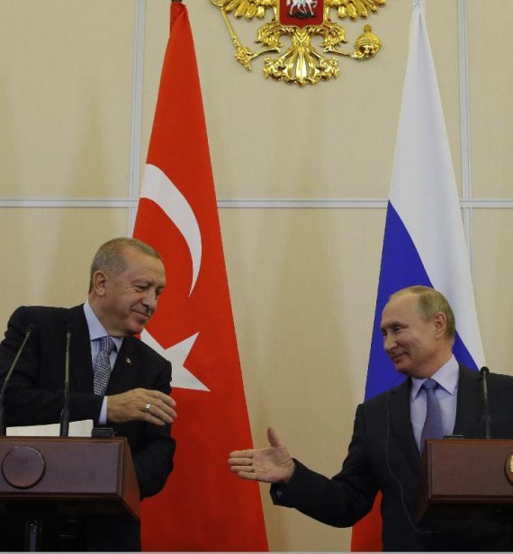 Russian President Vladimir Putin, right, and Turkish President Recep Tayyip Erdogan shake hands during a joint news conference after their talks in the Bocharov Ruchei residence in the Black Sea resort of Sochi, Russia, Tuesday, Oct. 22, 2019. Erdogan says Turkey and Russia have reached a deal in wh