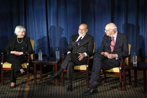 FILE - In this April 7, 2016, file photo Federal Reserve chair Janet Yellen, left, and former Federal Reserve chairs Ben Bernanke, center, and Paul Volcker, right, react as they listen to former Fed Chair Alan Greenspan appearing via video conference, during a panel discussion in New York. Volcker, 