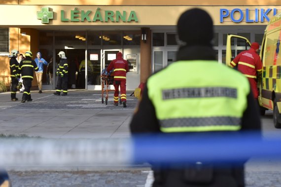 Firefighters, police officers and paramedics in front of the Ostrava Teaching Hospital, after a shooting incident in Ostava, Czech Republic, Tuesday, Dec. 10, 2019. Police and officials say at least four people have been killed in a shooting in a hospital in the eastern Czech Republic. Two others ar