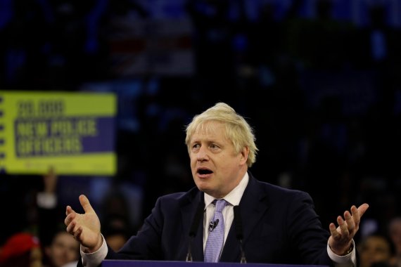 Britain's Prime Minister Boris Johnson speaks during his ruling Conservative Party's final election campaign rally at the Copper Box Arena in London, Wednesday, Dec. 11, 2019. Britain goes to the polls on Dec. 12. (AP Photo/Kirsty Wigglesworth)