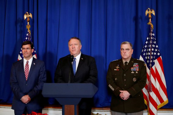 FILE PHOTO: U.S. Secretary of State Mike Pompeo speaks about airstrikes by the U.S. military in Iraq and Syria, at the Mar-a-Lago resort in Palm Beach, Florida, U.S., December 29, 2019. With him are U.S. Army General Mark Milley and U.S. Defense Secretary Mark Esper. REUTERS/Tom Brenner/File Photo /