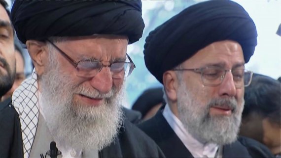 In this image taken from video, Iranian Supreme Leader Ayatollah Ali Khamenei, left, openly weeps as he leads a prayer over the coffin of Gen. Qassem Soleimani, who was killed in Iraq in a U.S. drone strike on Friday, at the Tehran University campus, in Tehran, Iran, Monday, Jan. 6, 2020. (Iran Pres