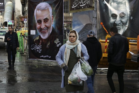 Pedestrians walk past banners of Iranian Revolutionary Guard Gen. Qassem Soleimani, who was killed in Iraq in a U.S. drone attack on Friday, in Tajrish square in northern Tehran, Iran, Thursday, Jan. 9, 2020. Many Iranians say they are relieved that neither their country nor the United States appear