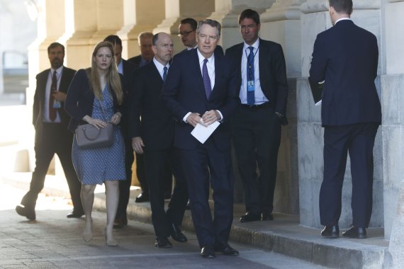 U.S. Trade Representative Robert Lighthizer, center, and members of his staff leave the U.S. Capitol, Thursday, Jan. 16, 2020. Earlier the Senate overwhelmingly approved a new North American trade agreement that rewrites the rules of trade with Canada and Mexico and gives President Donald Trump a ma