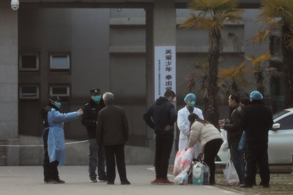 FILE PHOTO: Medical staff and security personnel stop patients' family members from being too close to the Jinyintan hospital, where the patients with pneumonia caused by the new strain of coronavirus are being treated, in Wuhan, Hubei province, China January 20, 2020. REUTERS/Stringer/File Photo /R