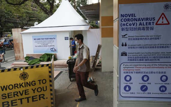 Workers set up a quarantine area for patients with recent travel history from China or those with symptoms of the new virus outside a private hospital in Manila, Philippines on Friday, Jan. 31, 2020. The World Health Organization declared the outbreak sparked by a new virus in China that has spread 
