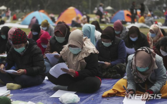 [홍콩=AP/뉴시스]2일(현지시간) 신종 코로나바이러스 감염증(우한폐렴)이 확산하는 가운데 홍콩 빅토리아 공원에서 인도네시아 이민 노동자들이 마스크를 쓴 채 영어를 공부하고 있다. 2020.02.03.