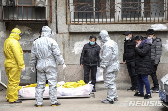 [우한=AP/뉴시스]지난 1일 중국 후베이성 우한에서 장의업자들이 신종 코로나바이러스 감염증으로 인한 사망자 시신을 옮기고 있다. 2020.02.03.