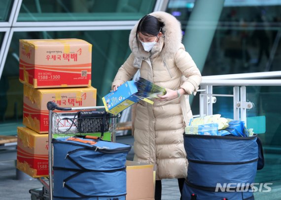 [인천공항=뉴시스]전신 기자 = 신종 코로나바이러스 감염증(우한 폐렴) 확산에 따른 마스크 품귀 현상이 빚어지는 가운데 4일 인천국제공항 출국장 앞에서 한 중국인이 대량의 마스크를 가방에 담고 있다. 2020.02.04. photo1006@newsis.com