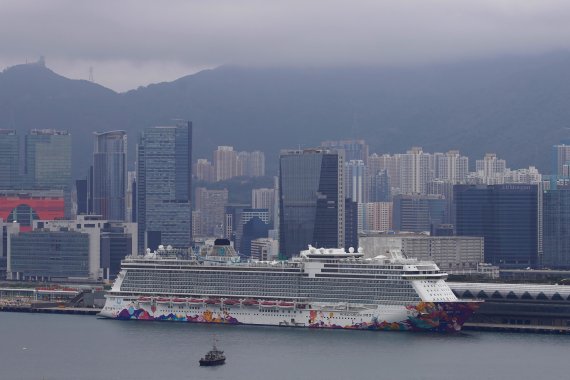 World Dream cruise ship is docked at Kai Tak cruise terminal in Hong Kong, Wednesday, Feb. 5, 2020. A Hong Kong official says more than 1,800 people on board the cruise ship that was turned away from a Taiwanese port will be quarantined until they are checked for a new virus. (AP Photo/Vincent Yu) /