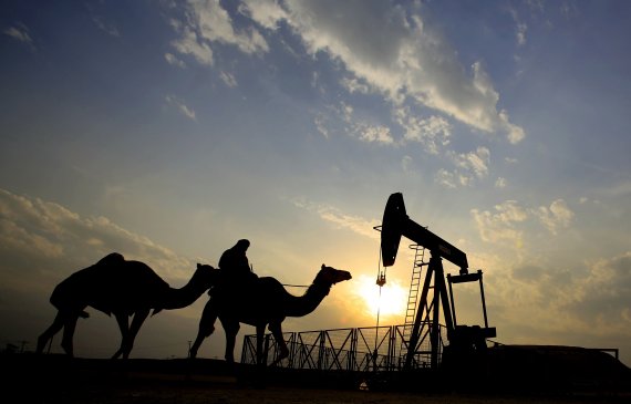 FILE- In this Dec. 20, 2015 file photo, a man rides a camel through the desert oil field and winter camping area of Sakhir, Bahrain. (AP Photo/Hasan Jamali, File) /뉴시스/AP /사진=